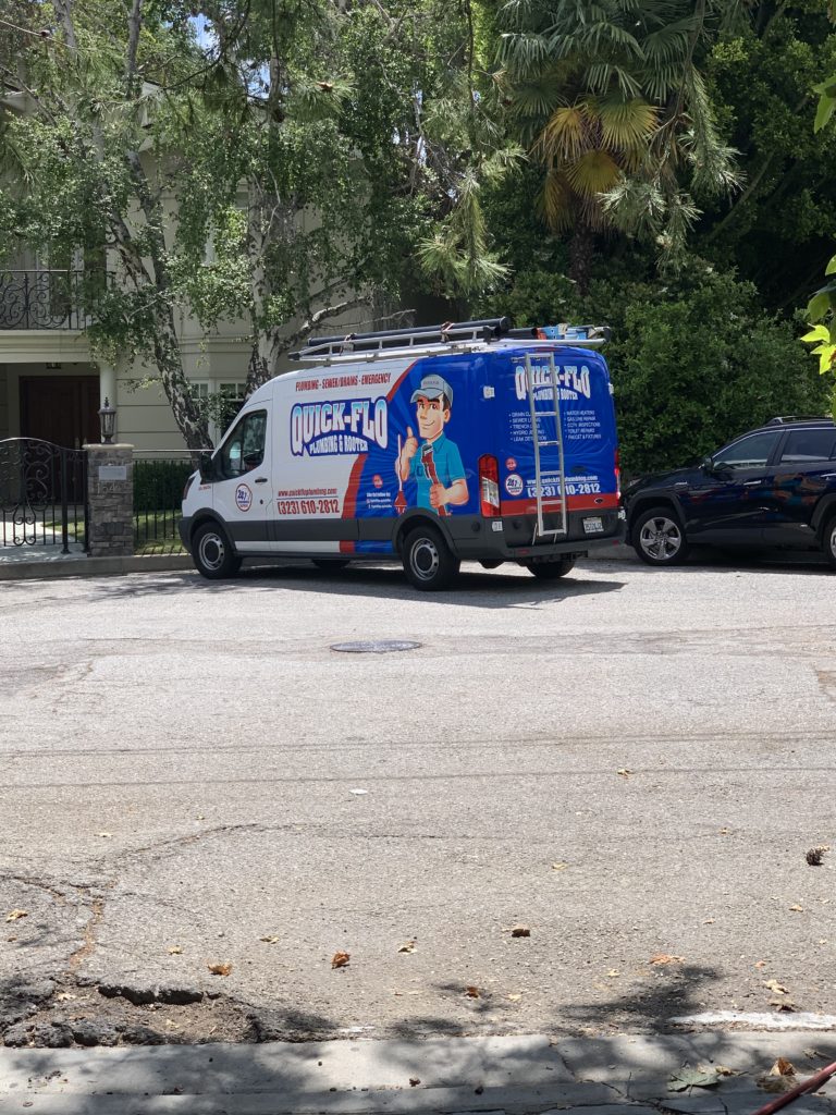 Quick Flo Plumbing Van parked outside the house